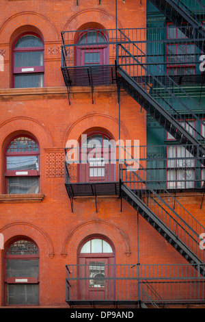 Red brick apartment building with fire escapes, SOHO, Manhattan, New York City, USA Stock Photo