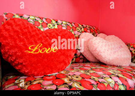 Fluffy "love" pillows in red and pink Stock Photo