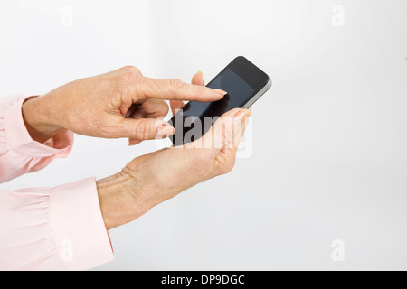 Cropped image of senior businesswoman using smart phone in office Stock Photo
