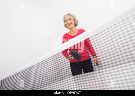 Senior female table tennis player laughing Stock Photo