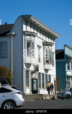 A couple with a  child strolls along the main street  in Mendocino, California Stock Photo