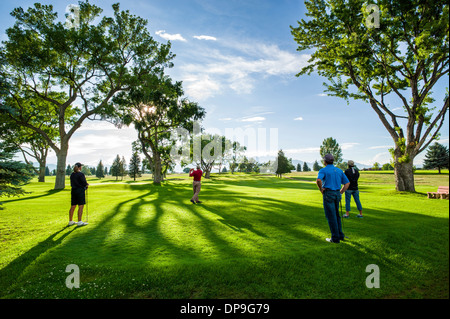 Backlit view of late afternoon light on lush nine hole Salida, Colorado, Golf Course Stock Photo