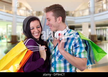 A young couple having fun while shopping in a shopping mall Stock Photo