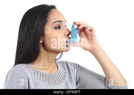 Asthmatic arab woman breathing from a inhaler isolated on a white background Stock Photo