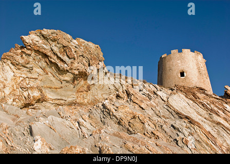 Cala Piscinni, small beach in Baia Chia, in south west of Sardinia Island, near Cagliari. The ancient Tower on top of the rocks Stock Photo