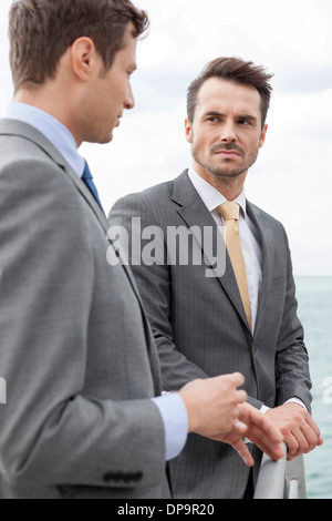 Businessmen having a discussion on terrace Stock Photo