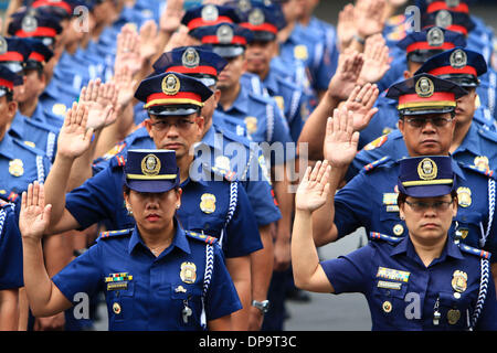 Quezon City, Philippines. 10th Jan, 2014. Newly-promoted policemen and policewomen of the Philippine National Police (PNP) take their oath during the donning of ranks inside Camp Crame in Quezon City, the Philippines, Jan. 10, 2014. A total of 11,093 officers of the PNP were appointed to higher ranks all over the Philippines. Credit:  Rouelle Umali/Xinhua/Alamy Live News Stock Photo