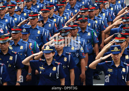 Quezon City, Philippines. 10th Jan, 2014. Newly-promoted policemen and policewomen of the Philippine National Police (PNP) take their oath during the donning of ranks inside Camp Crame in Quezon City, the Philippines, Jan. 10, 2014. A total of 11,093 officers of the PNP were appointed to higher ranks all over the Philippines. Credit:  Rouelle Umali/Xinhua/Alamy Live News Stock Photo