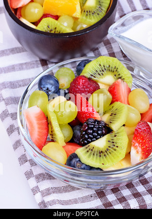 Fruit salad with strawberries, oranges, kiwi and blueberries isolated on white background Stock Photo