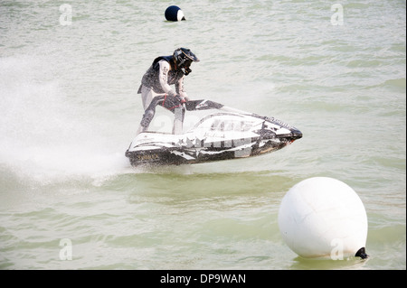 Jet ski contestant with a helmet riding a jet ski contest on the river Stock Photo