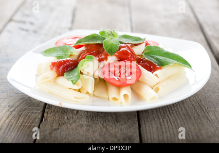Pasta with vegetables on a wooden table Stock Photo