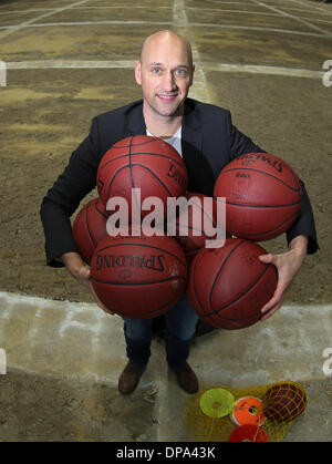 Hamburg, Germany. 08th Jan, 2014. Former German Basketball national player Pascal Roller holds basketballs in Hamburg, Germany, 08 January 2014. Roller plans to launch the Hamburg Towers to the German Basketball Bundesliga in October. Photo: AXEL HEIMKEN/dpa/Alamy Live News Stock Photo