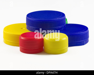 Bunch of multicolored used plastic bottle caps on white background Stock Photo