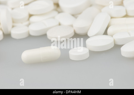 many white drugs pills shapes texture background Stock Photo