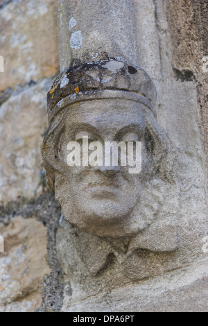 Medieval stone carvings on exterior walls of St. Mary's Church, Lower Slaughter in the Cotswolds. Stock Photo