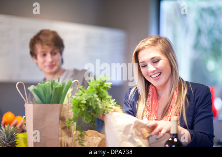 Young couple unpacking groceries Stock Photo