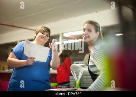 Young woman ordering from menu in cafe Stock Photo