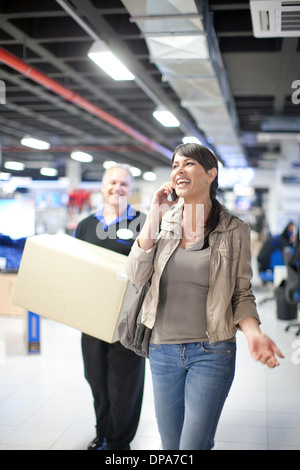 Woman leaving showroom with purchase Stock Photo