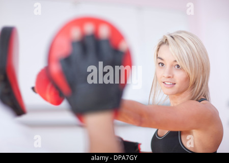 Young woman boxing in gym Stock Photo