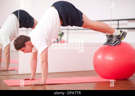 Young man training with exercise ball Stock Photo