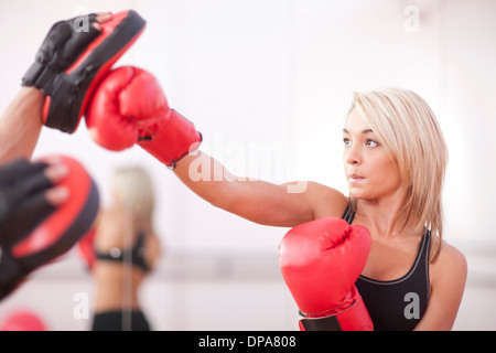 Young woman training in boxing gloves Stock Photo
