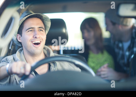 Young adult friends driving in car Stock Photo