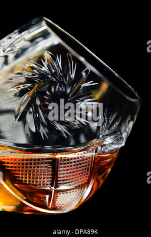 old snifter with brandy , isolated in black , saved clipping path Stock Photo