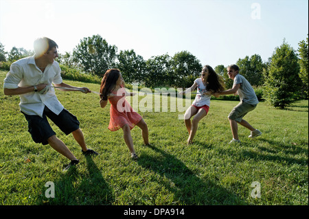 Group of young adults playing tug of war Stock Photo