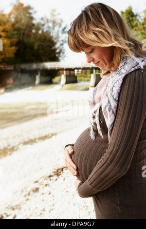 Portrait of pregnant woman looking down Stock Photo