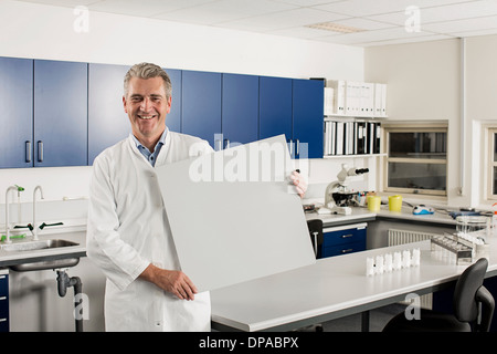 Male scientist in laboratory with blank sign Stock Photo