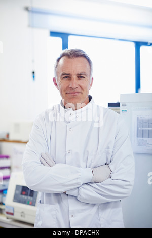 Portrait of researcher standing in lab wearing lab coat Stock Photo