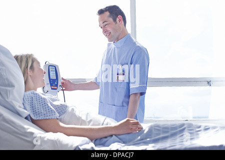 Nurse taking patient's blood pressure Stock Photo