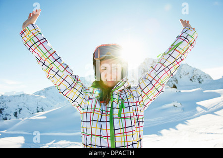Portrait of teenage girl skier with arms outstretched, Les Arcs, Haute-Savoie, France Stock Photo