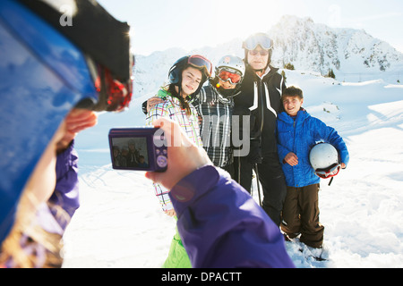 Girl photographing family, Les Arcs, Haute-Savoie, France Stock Photo