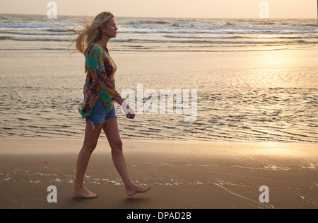 Nude woman walking on beach Stock Photo - Alamy