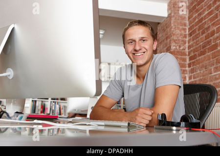 Portrait of young man at desk Stock Photo