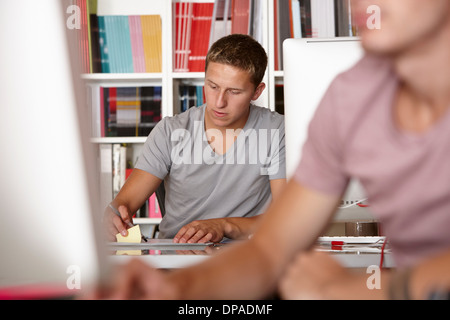 Young men working, focus on background Stock Photo