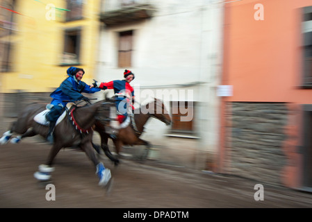 Couple ride reckless horserace 'Sa Carrela e Nanti', during the carnival at Santu Lussurgiu, Oristano, Sardinia, Italy, Europe Stock Photo