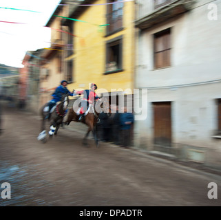 Couple ride reckless horserace 'Sa Carrela e Nanti', during the carnival at Santu Lussurgiu, Oristano, Sardinia, Italy, Europe Stock Photo