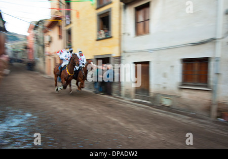 Couple ride reckless horserace 'Sa Carrela e Nanti', during the carnival at Santu Lussurgiu, Oristano, Sardinia, Italy, Europe Stock Photo