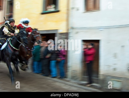 Couple ride reckless horserace 'Sa Carrela e Nanti', during the carnival at Santu Lussurgiu, Oristano, Sardinia, Italy, Europe Stock Photo