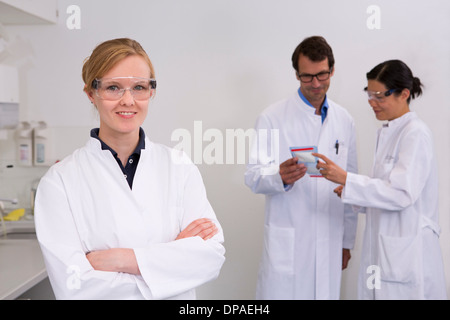 Group of scientists working in laboratory Stock Photo