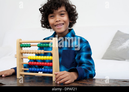 Boy playing with abacus Stock Photo