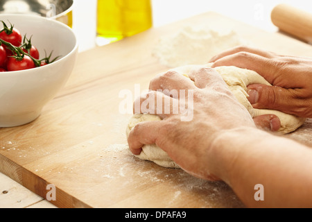 Hands kneading dough Stock Photo