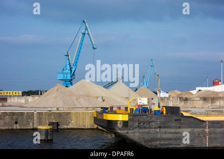 Dock cranes and heaps of sand at the Ch. Kesteleyn gravel terminal in the port of Ghent, East Flanders, Belgium Stock Photo