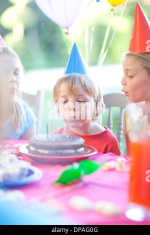 Brother and his sisters enjoying birthday party Stock Photo