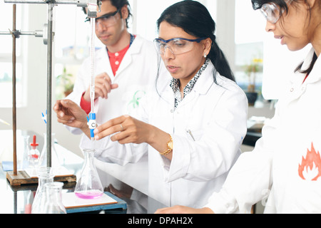 Chemistry teacher doing experiment with students Stock Photo