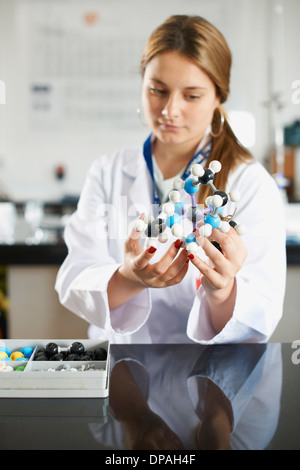 Teenage girl holding molecular model Stock Photo