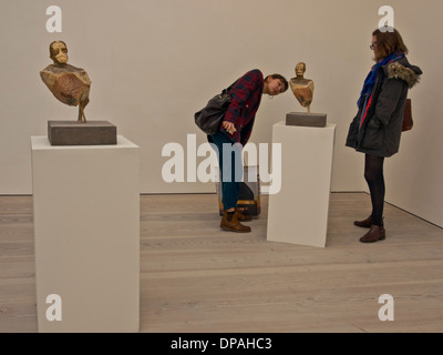 Visitors to an exhibition at the Saatchi Gallery, London, UK Stock Photo