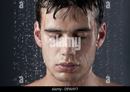 Young man covered with water droplets Stock Photo